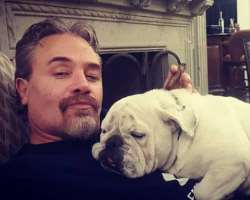 The star is accompanied by a cute dog in his home. He loves to spend his free time with this dog.